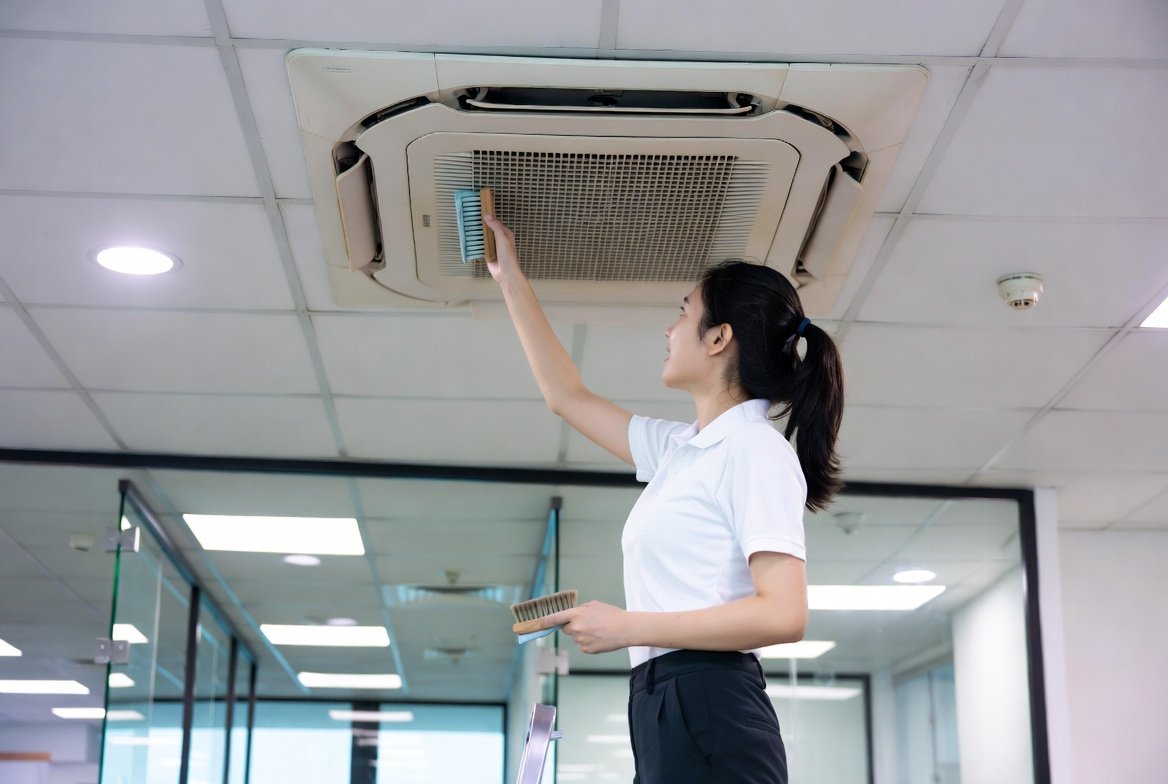 Technician performing chemical wash and maintenance on a split aircon unit in Singapore
